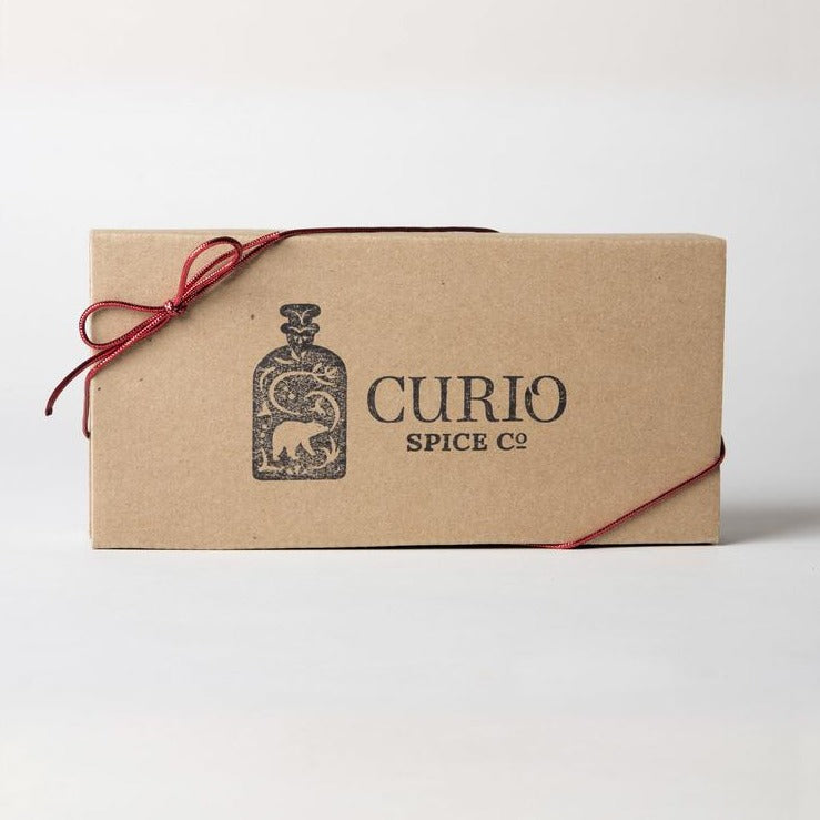 carton box with ribbon filled with 3 tins with spice and salt blends