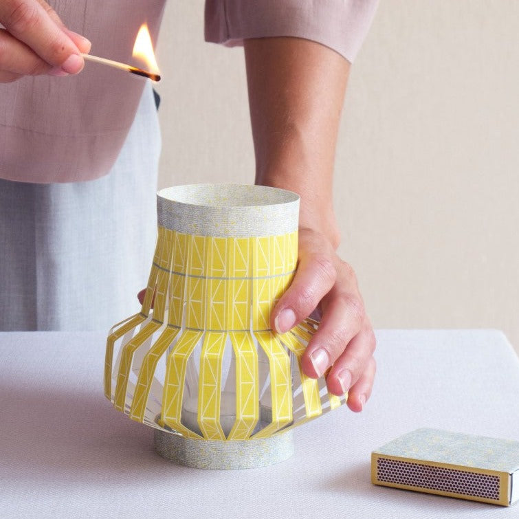 yellow lantern made from paper to put around a glass as party light