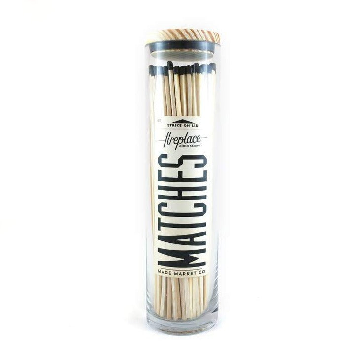 black tall matches in a glass jar with vintage label 