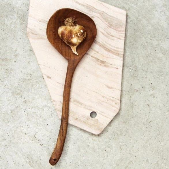 wooden spoon on pink marble board