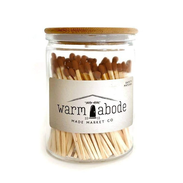 camel colored matches in a glass vessel with lid