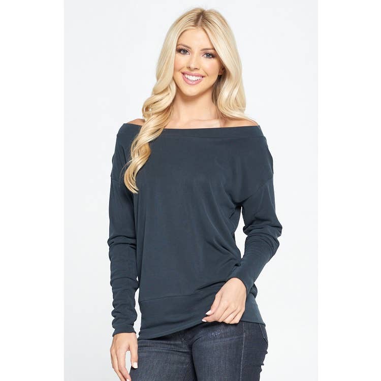 blond lady with dark jeans in combination with a black off shoulder knitted sweater