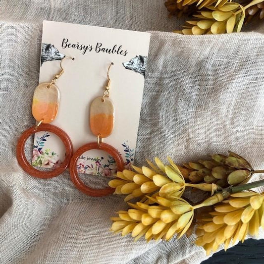 orange and terracotta colored long handmade dangler earrings