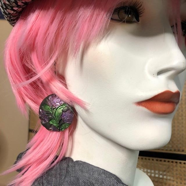 purple and green metailc flowers on a round black earring