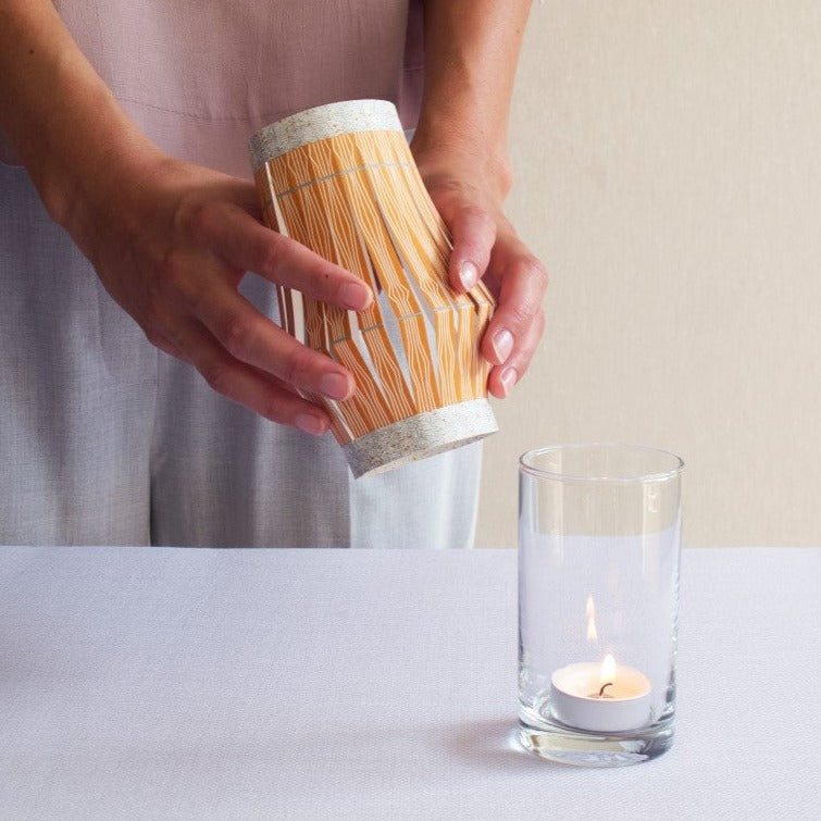 paper lntern in orange to cover a glass and create party light