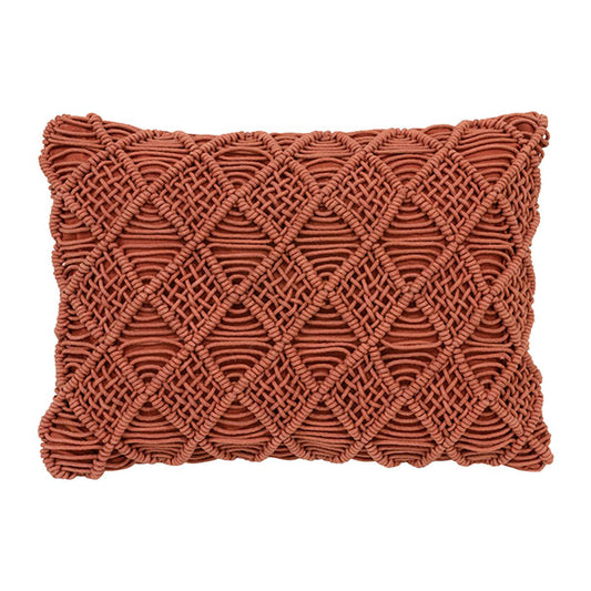 lumbar pillow in an orange color with a textured macramé front 